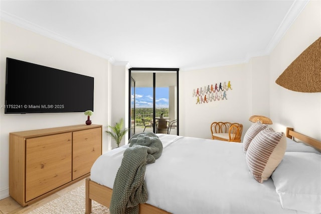 bedroom featuring access to exterior, ornamental molding, and a wall of windows