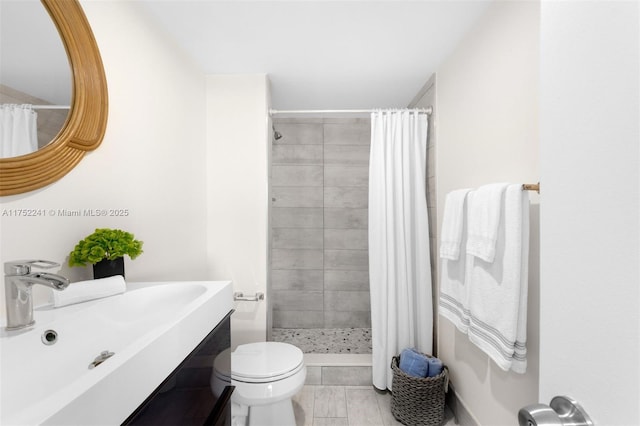 full bathroom featuring a stall shower, vanity, and toilet