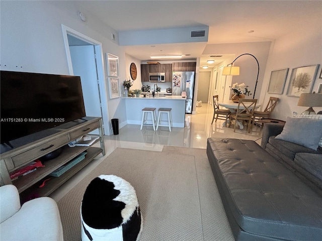 living room with visible vents and baseboards