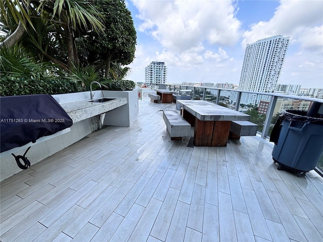 view of patio / terrace with a view of city, outdoor dry bar, an outdoor kitchen, and grilling area