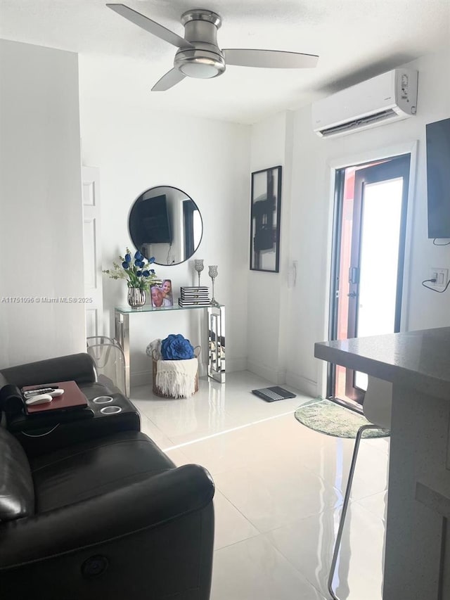 tiled living area featuring a wall unit AC and a ceiling fan