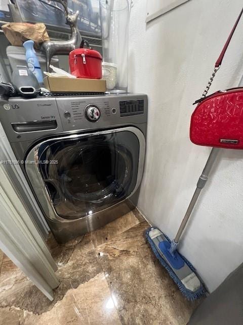 laundry area featuring washer / dryer and laundry area