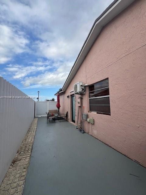 view of home's exterior featuring a patio area, fence, and stucco siding