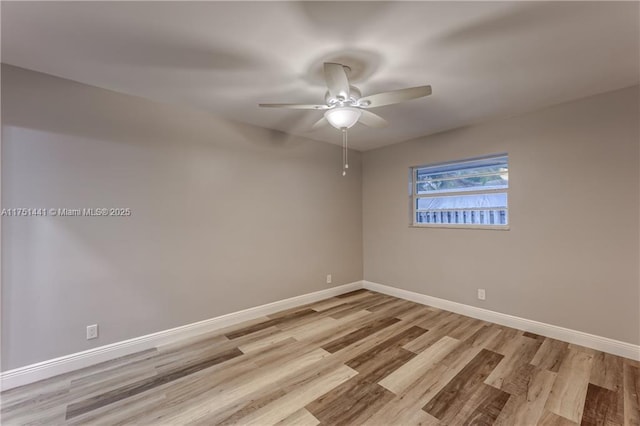 unfurnished room featuring light wood-type flooring, a ceiling fan, and baseboards