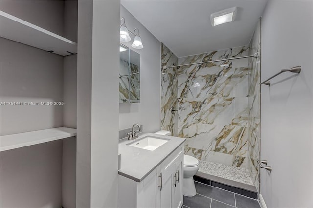 full bath featuring toilet, tile patterned flooring, a shower stall, and vanity