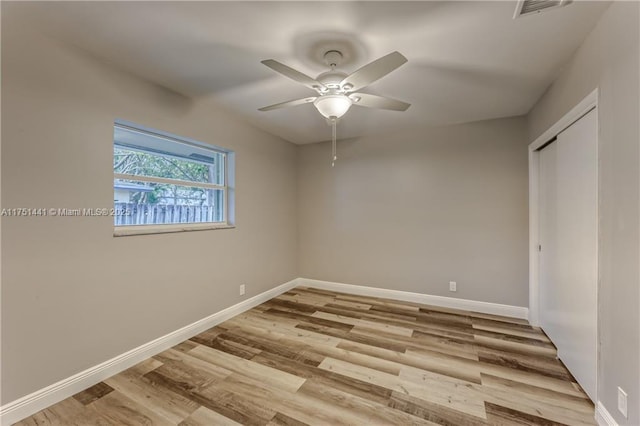 unfurnished bedroom featuring visible vents, baseboards, a ceiling fan, light wood-style floors, and a closet