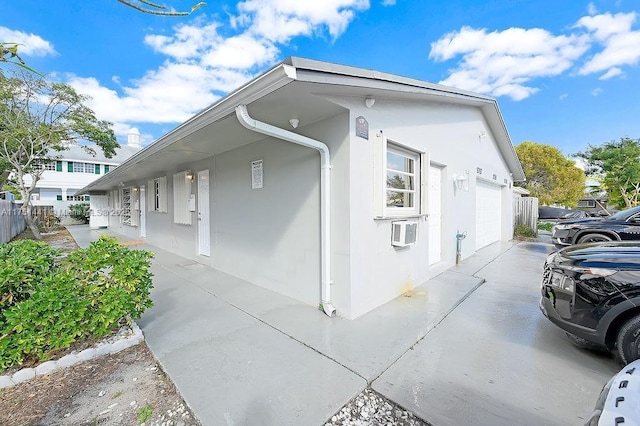 view of home's exterior featuring concrete driveway and stucco siding