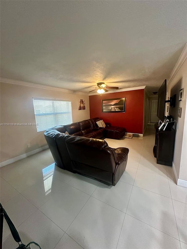 living room with crown molding, a ceiling fan, light tile patterned flooring, a textured ceiling, and baseboards