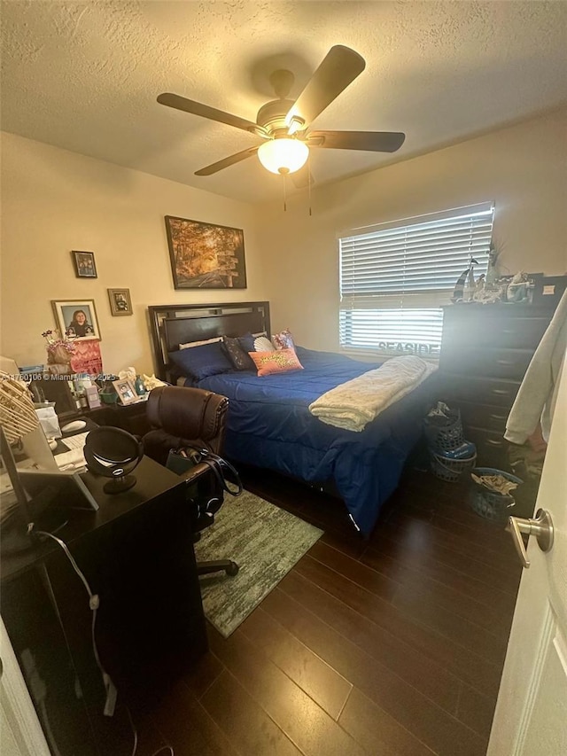 bedroom featuring a textured ceiling, a ceiling fan, and hardwood / wood-style floors