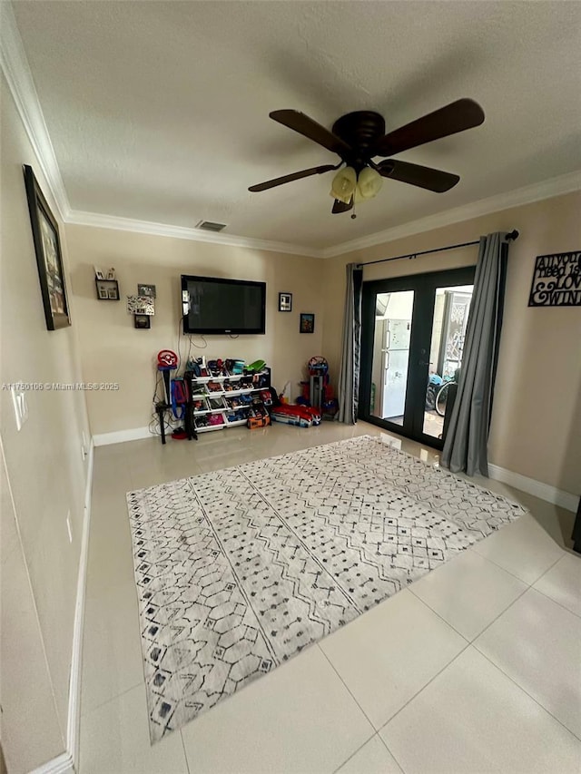 interior space featuring a textured ceiling, french doors, ornamental molding, and baseboards