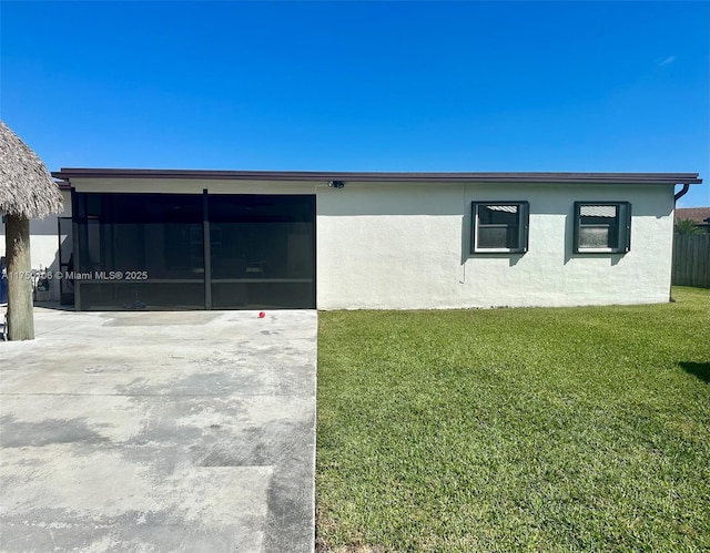 view of side of home featuring a yard and stucco siding