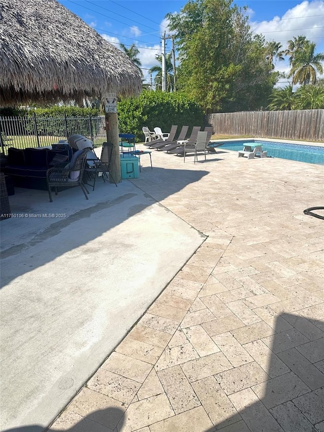 view of patio / terrace featuring a gazebo, fence, and a fenced in pool