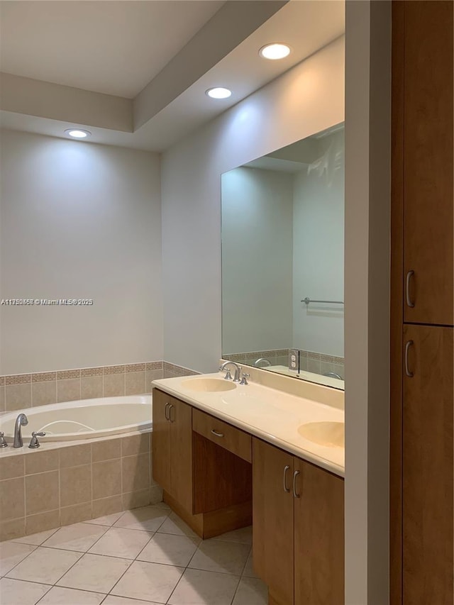 full bath featuring double vanity, tile patterned floors, a garden tub, a sink, and recessed lighting