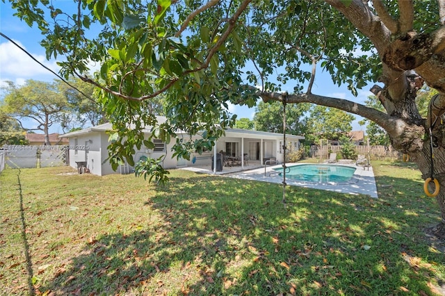 940 SW 52nd Ave, Plantation, FL 33317 - exterior space featuring a sunroom, a lawn, a fenced backyard, a patio, and a fenced in pool