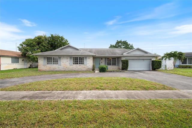 single story home featuring driveway, an attached garage, and a front yard