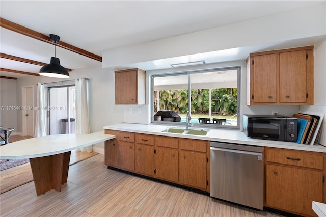 kitchen with decorative light fixtures, light countertops, a sink, black microwave, and dishwasher