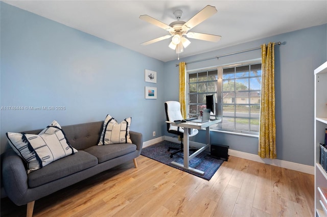 office area featuring ceiling fan, wood finished floors, and baseboards