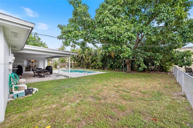 view of yard featuring a patio area, a fenced backyard, and a fenced in pool