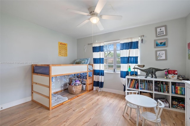 bedroom featuring a ceiling fan, baseboards, and light wood finished floors