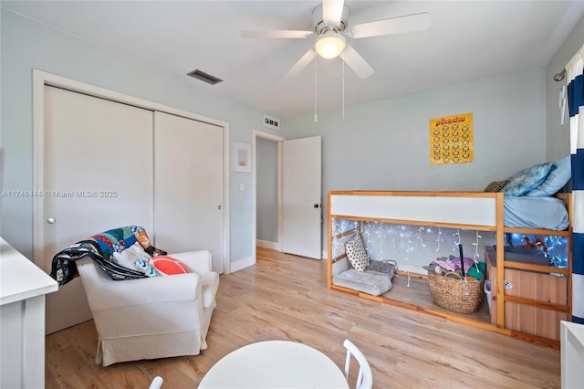 bedroom featuring a closet, visible vents, and light wood finished floors