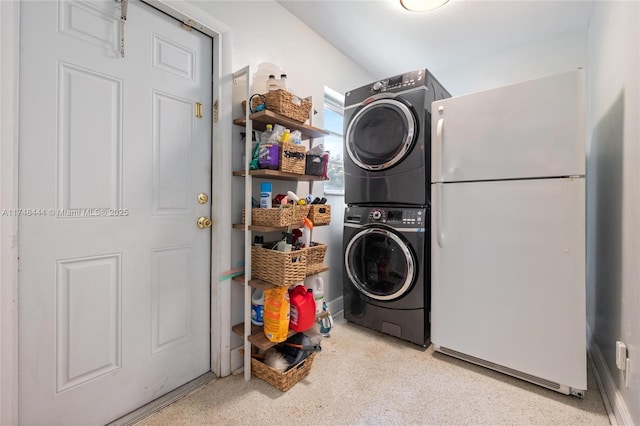 laundry room featuring stacked washer / dryer and laundry area