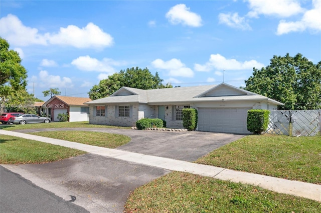 940 SW 52nd Ave, Plantation, FL 33317 - single story home with a front yard, fence, a garage, and aphalt driveway