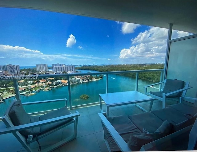 balcony featuring a view of city and a water view