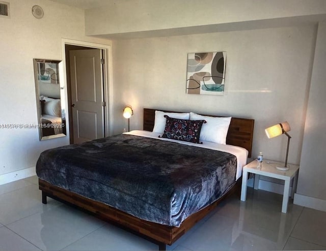 bedroom with visible vents, baseboards, and light tile patterned flooring