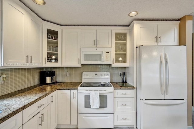 kitchen with glass insert cabinets, stone countertops, white appliances, and white cabinets