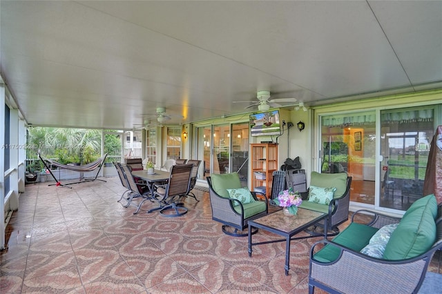 sunroom featuring a ceiling fan