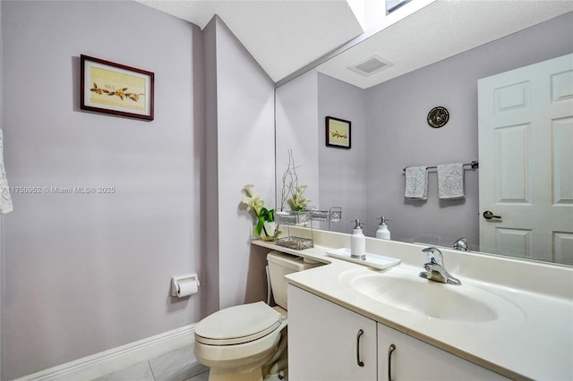 half bathroom featuring baseboards, visible vents, vanity, and toilet