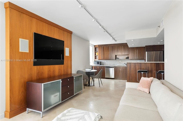 living area featuring visible vents and track lighting