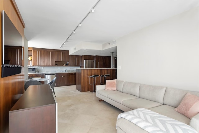 living room with rail lighting and visible vents