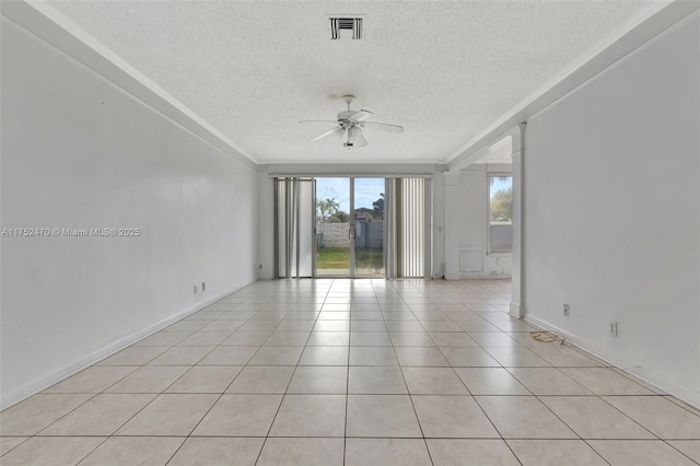 spare room with light tile patterned floors, a textured ceiling, visible vents, baseboards, and a ceiling fan