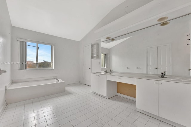 full bath featuring lofted ceiling, tile patterned flooring, a garden tub, a sink, and double vanity