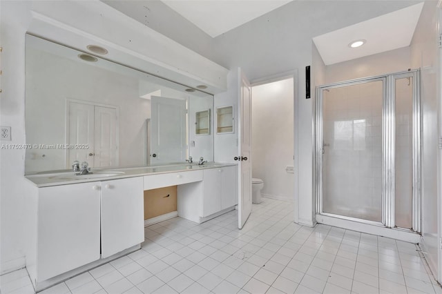 bathroom with toilet, a sink, a shower stall, tile patterned floors, and double vanity