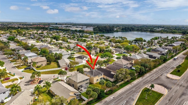 birds eye view of property with a water view and a residential view