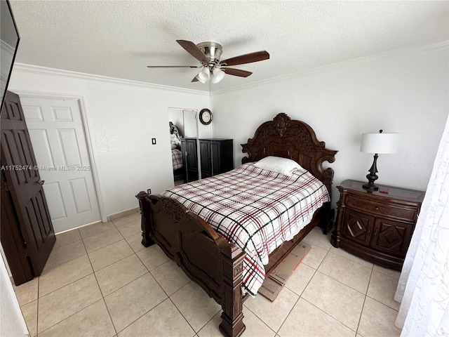 bedroom featuring ornamental molding, light tile patterned flooring, a textured ceiling, and a ceiling fan