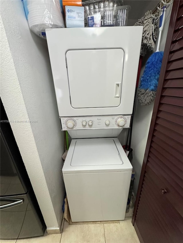 laundry room with stacked washer and dryer and laundry area