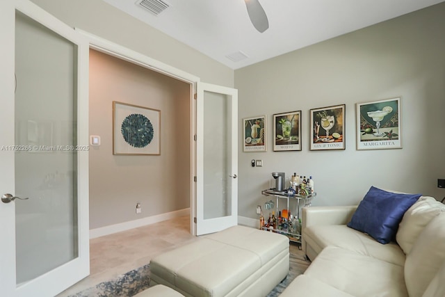 living area with french doors, a ceiling fan, visible vents, and baseboards