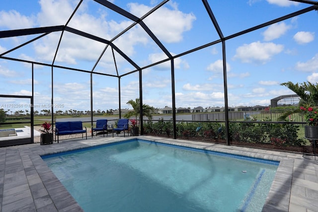 outdoor pool with a lanai and a patio area