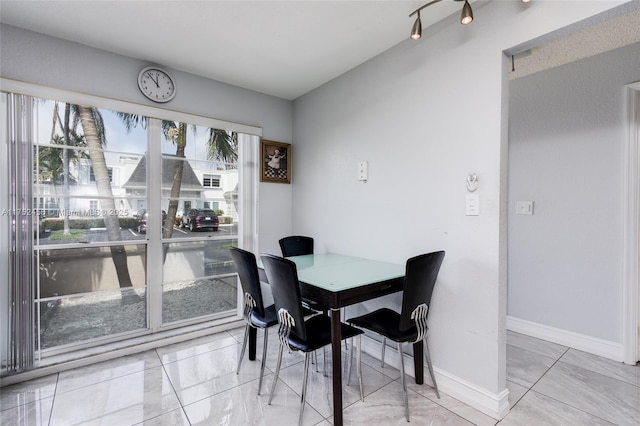 dining area featuring baseboards