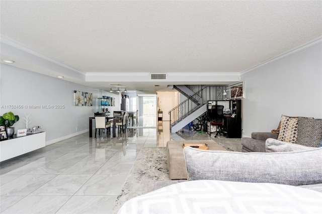 living room featuring stairs, visible vents, a textured ceiling, and ornamental molding