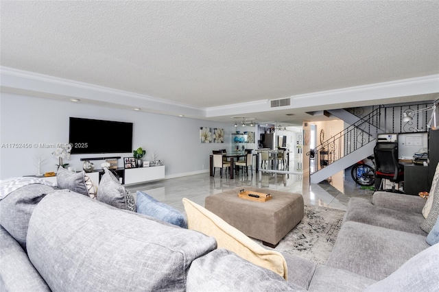 living area featuring a textured ceiling, visible vents, baseboards, ornamental molding, and stairway