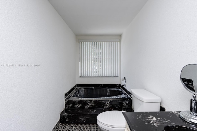 bathroom featuring toilet and a bath