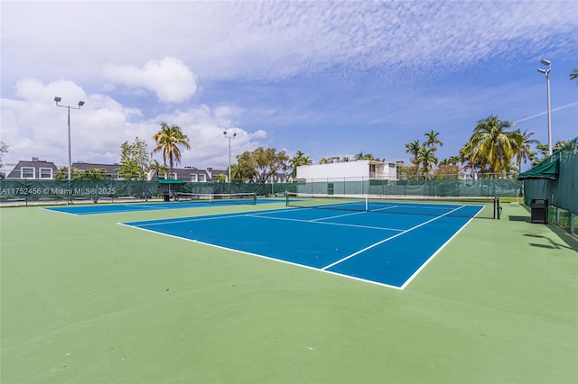 view of tennis court with fence