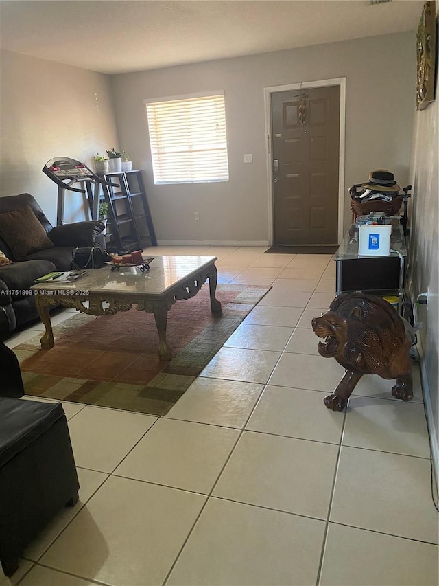 living room featuring tile patterned flooring and baseboards