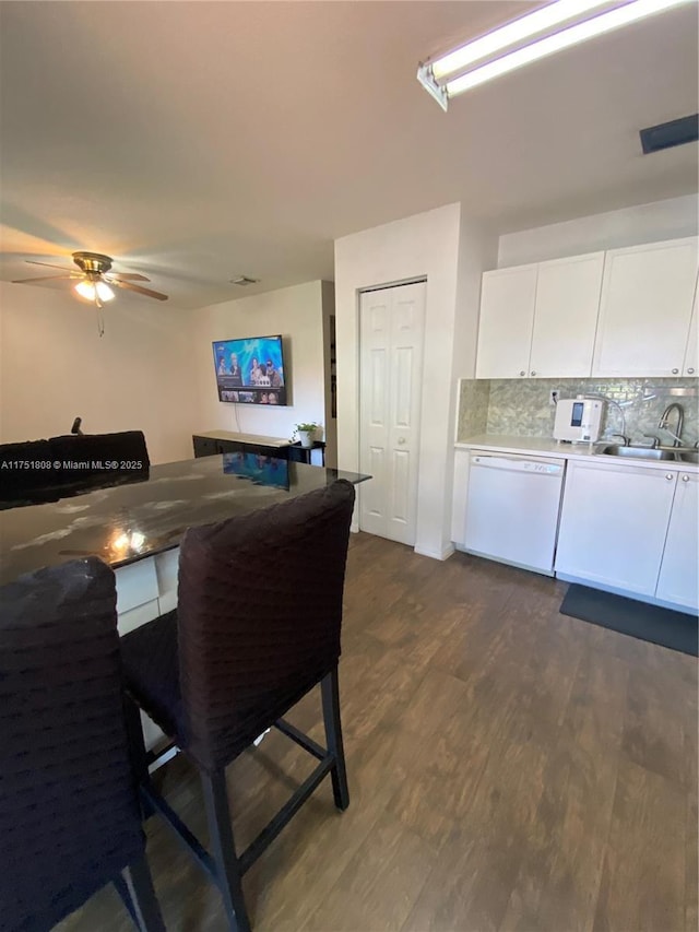 dining area with dark wood finished floors and a ceiling fan