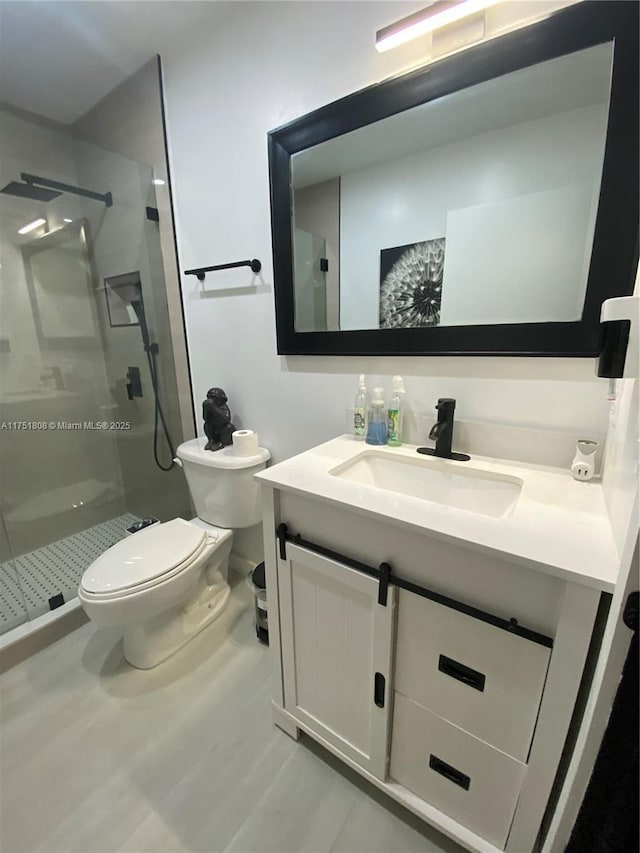 full bath with toilet, a stall shower, and vanity