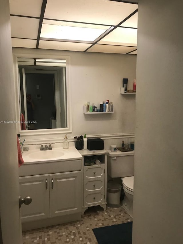 bathroom featuring wainscoting, vanity, and toilet